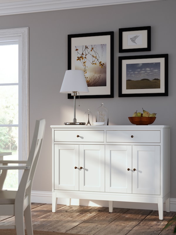 阳光筛选与白色的木地板房间IDANAS餐具柜靠墙排列的艺术。