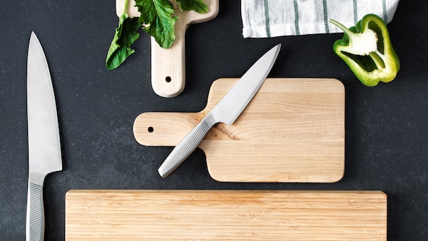 厨师在不锈钢的刀是躺在木案板旁边的一个大厨师的刀。