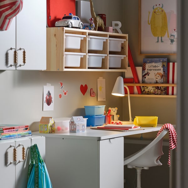 白色LARANDE桌子撤离存储单元靠墙站在某些TROFAST墙存储在一个孩子的房间。