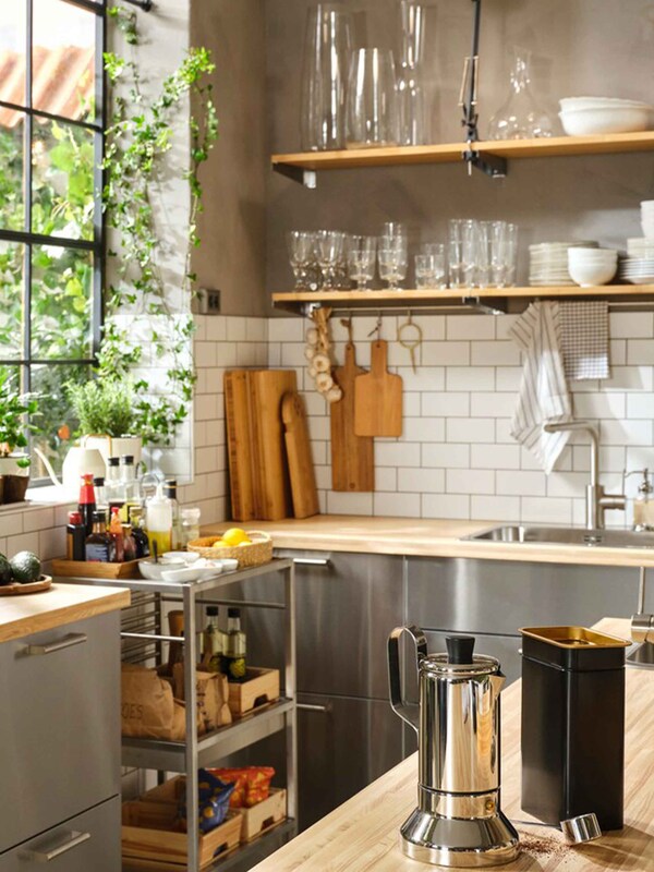 的角落里一个大厨房和一个大窗口,木制工作上衣,不锈钢餐具方面和开放的架子。